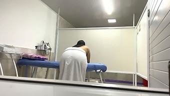 A Latina Nurse Massages A Patient'S Large Butt In The Office